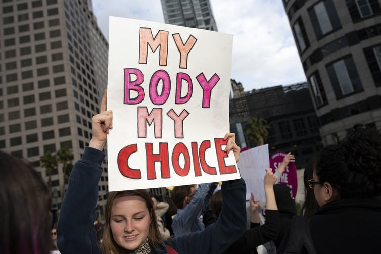 Protester holding a my body my choice sign at a demonstration