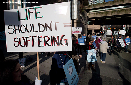People demonstrate outside the B.C. Court of Appeal during a hearing into the federal governments appeal of the B.C. Supreme Court ruling that struck down the laws making physician-assisted dying illegal, in Vancouver, B.C., on Monday March 4, 2013. THE CANADIAN PRESS/Darryl Dyck